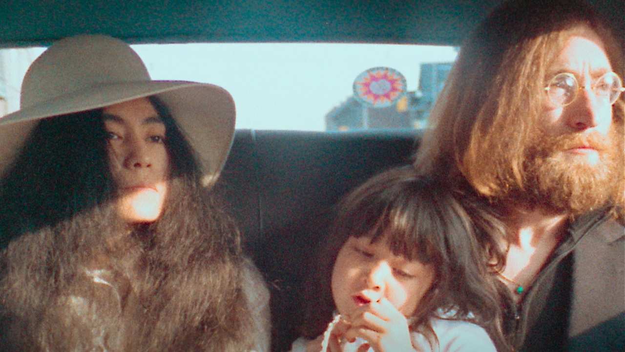 Yoko Ono, John Lennon and a baby in a car